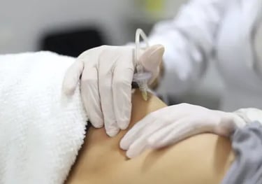 a person in a white shirt is getting a tattoo on their back