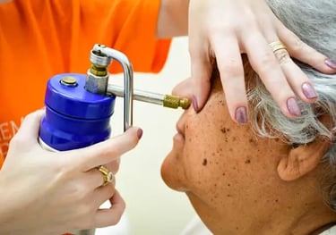 a woman is getting her hair brushed off by a hair dryer