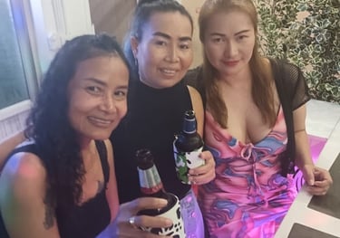 three women sitting at a table with drinks
