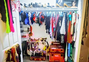 a closet with a closet full of clothes and a suitcase
