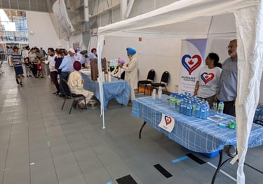 Volunteers hosting a water donation camp at a community event, providing free water to locals