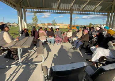 A doctor leading a health and well-being discussion with seniors during a speaker session.