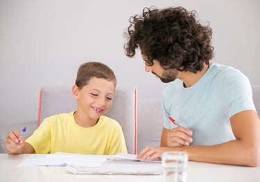 <a href="https://www.freepik.com/free-photo/happy-boy-his-dad-doing-school-home-task-together-writin