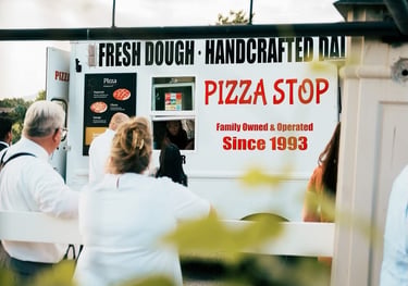 wedding guests waiting to get pizza at a pizza truck