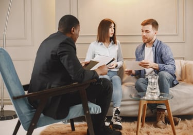 a man and woman sitting on a couch in a living room