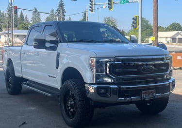 a ford power stroke with a lift kit and new tires from premier tire in sandpoint idaho