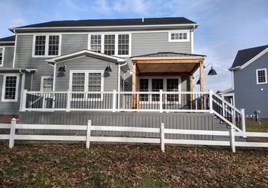 Composite deck with vinyl rails, aluminum balusters and a cedar frame Pavilion