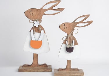 a couple of wooden rabbits with a bag of stuff for easter festival