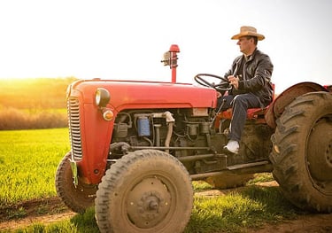 a man in a cowboy hat sitting on a tractor