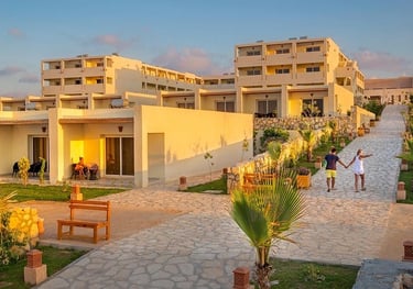 a couple of people walking down a path in front of a building | Nour Nagy Designs