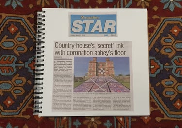 Ring-bound square book showing a newspaper clipping from the Shropshire Star