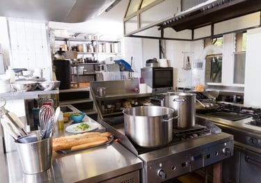a kitchen with a stove top and a potted potted with bread