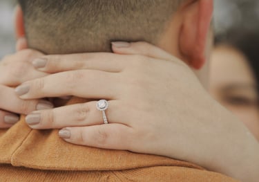 a man and woman holding hands and wearing rings
