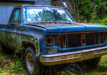 A blue truck parked in front of a Surrey house