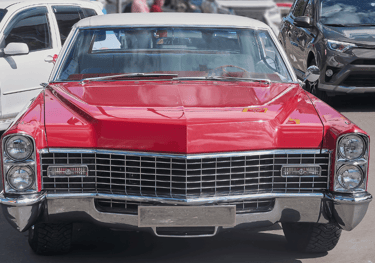 a red car parked in a Surrey parking lot
