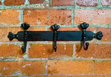 Metal Coat rack attached to brick wall