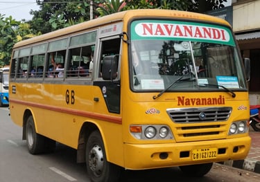 A modern school bus with happy children boarding safely under supervision.