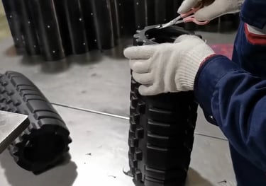 Core tube inserted into foam roller during assembly process