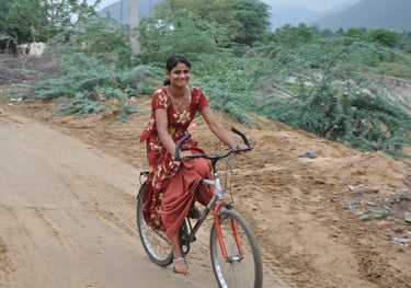 A lady cycling past our hotel, the Gulaab Niiwaas Palace,  Pushkar , Rajasthan, India