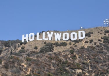 a large hollywood sign on a hill with a blue sky in the background