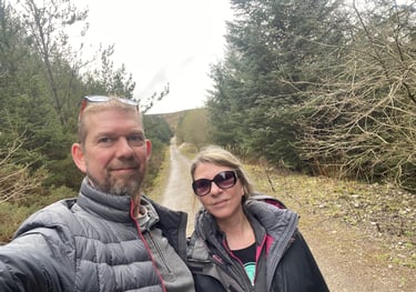 nick and tracey billington on the footpath through the woods on Moel Famau, wales