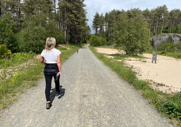 Tracey Billington walking through Newborough nature reserve forest