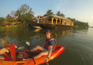 Nick and Tracey Billington canoeing on the waterway at Alappuzha, Kerala, India