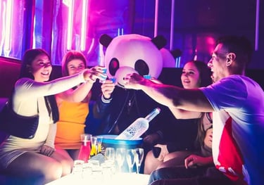 a group of people sitting around a table with drinks