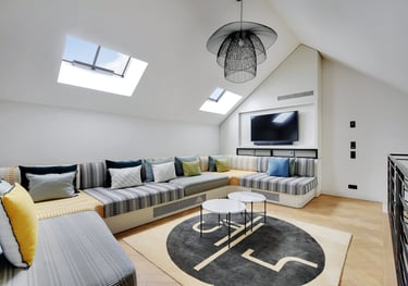 Mezzanine lounge at Villa Bastille with arcade games and TV