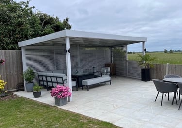 A modern porcelain slab patio area and pergola with roof