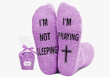 Picture of bottom of socks that says NOT Sleeping but Praying.