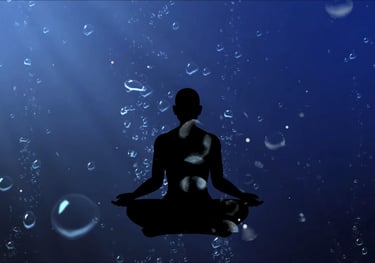 Silhouette of meditation figure deep underwater with bubbles rising