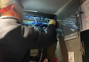 a man in a suit and glasses working on a computer