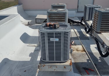 a couple of air conditioning units on a roof top