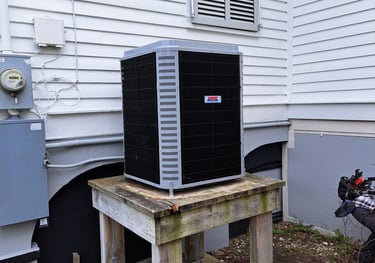 a small air conditioner sitting on a wooden table