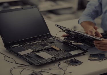 a man is holding a laptop computer and a laptop