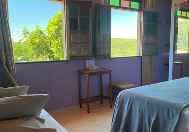a bedroom with a bed and a table with pillows