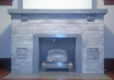 Light gray and gray-blue custom painted and partially stained brick fireplace and mantle
