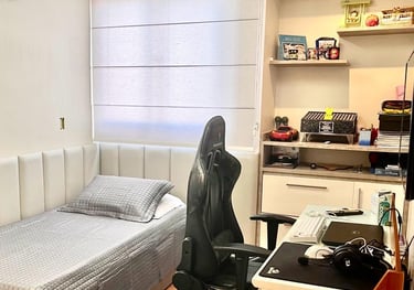 a bedroom with a bed and desk area
