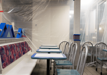 a renovated restaurant with a long table and chairs