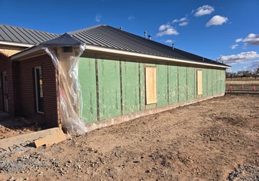 after the brick demolition begins with boarded windows by Red Dirt Ditching and Septic LLC