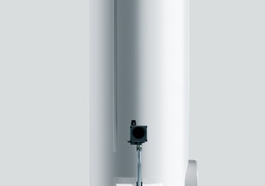 a white tankless water heater with a black top