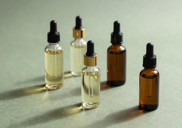 A clean, artistic shot of botanical extracts and clear oils in aesthetic bottles, placed on a sage green fabric, reflecting a calm and natural beauty mood.