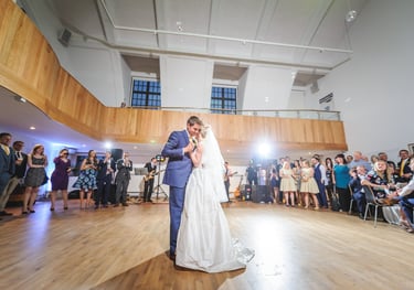 a bride and groom share a first dance at a wedding at Penarth Pier Pavilion