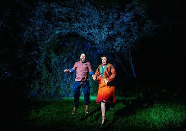 a couple of people standing in the grass