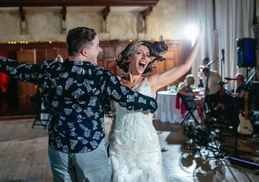 Bride dances with guest during South Wales wedding reception, captured in energetic candid style by photographer Owen Mathias