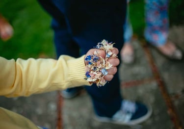 a person holding confetti in a grip in their hand