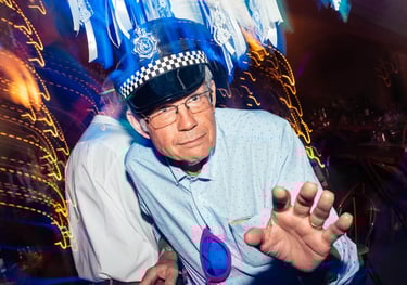 a man in a police hat dancing at a wedding
