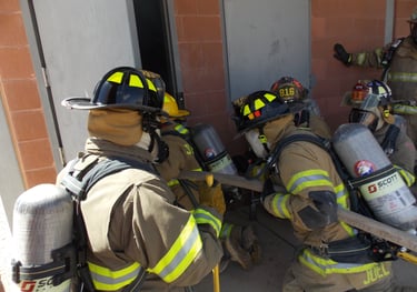 a group of firefighters in full gear training