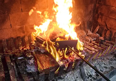 Extra long firerake being used on an outdoor fireplace in nz